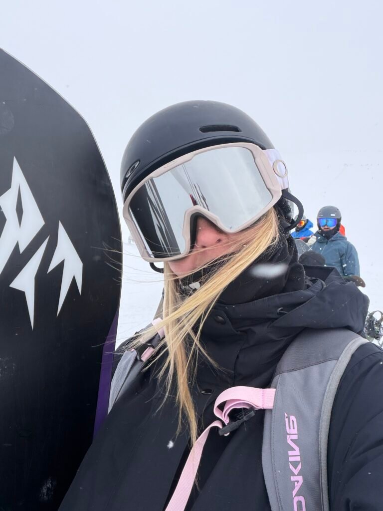 Snowboarder in goggles on a bluebird day