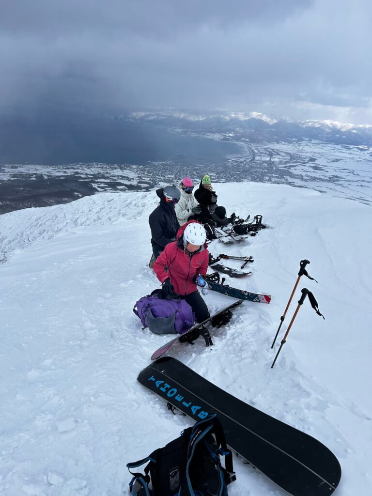 Friends taking a break on the backcountry tour with the coast below