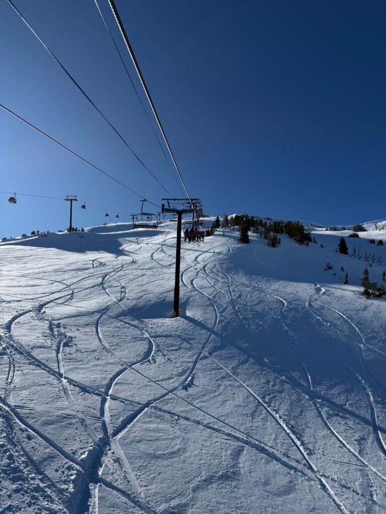 Chairlift towers over fresh corduroy at Mammoth Mountain