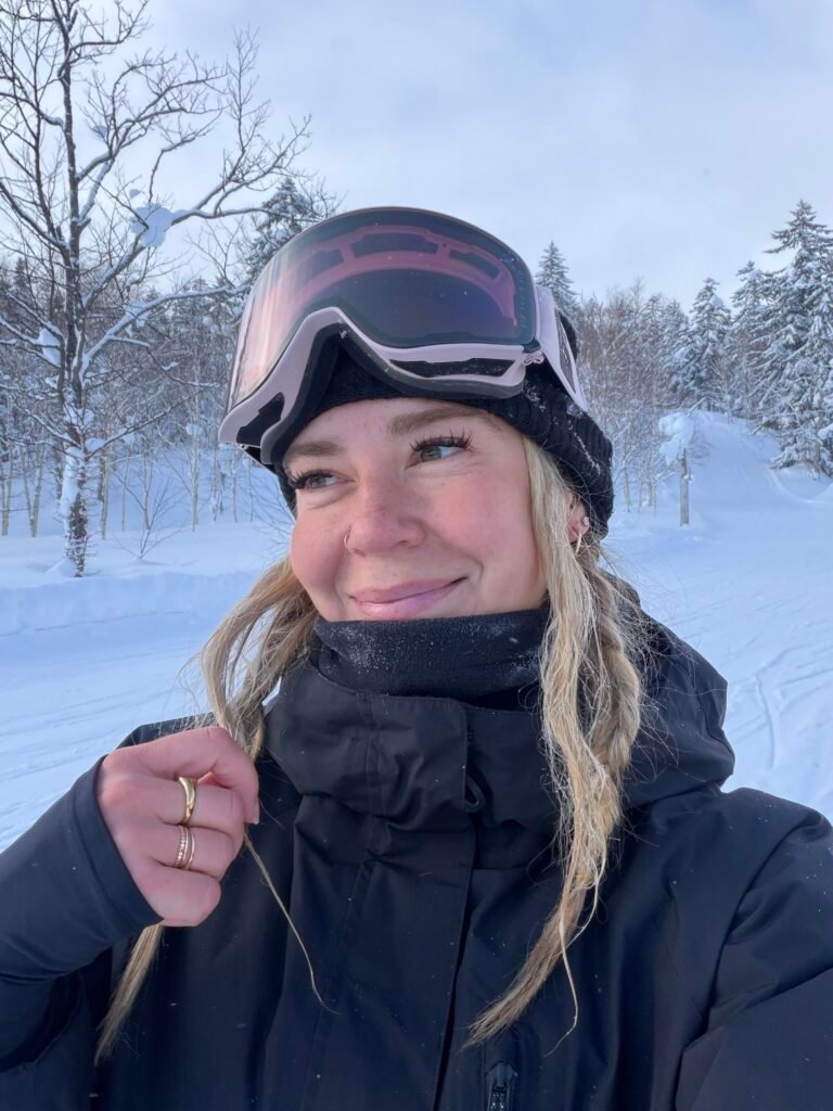 Smiling selfie in a snowy forest on the first day in Hokkaido