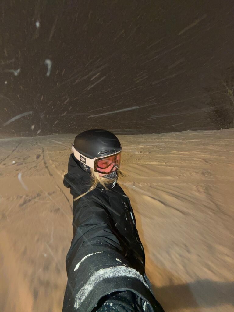 Night riding in Niseko with snow falling under the lights