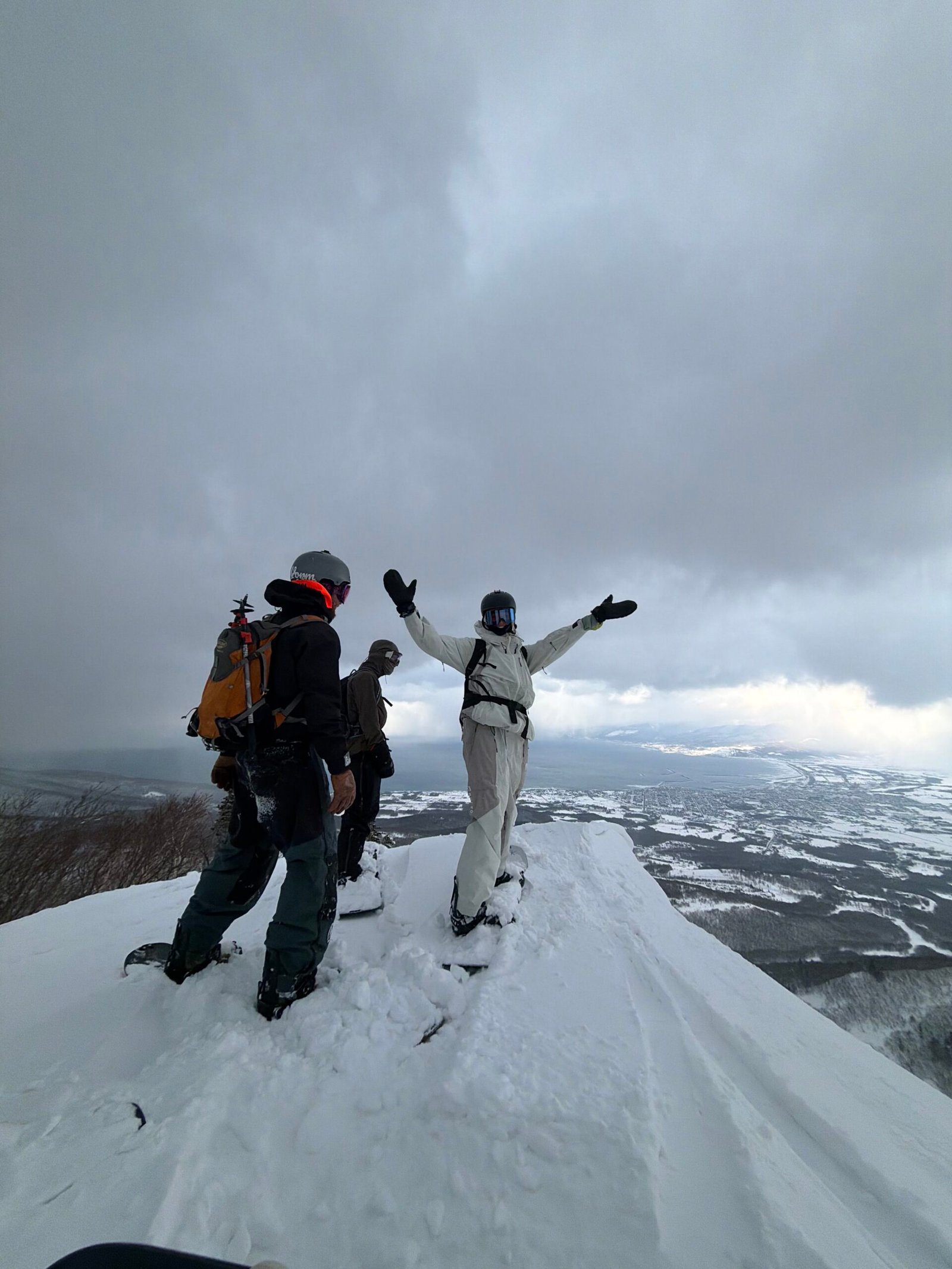 Friends celebrating at the top of the backcountry climb