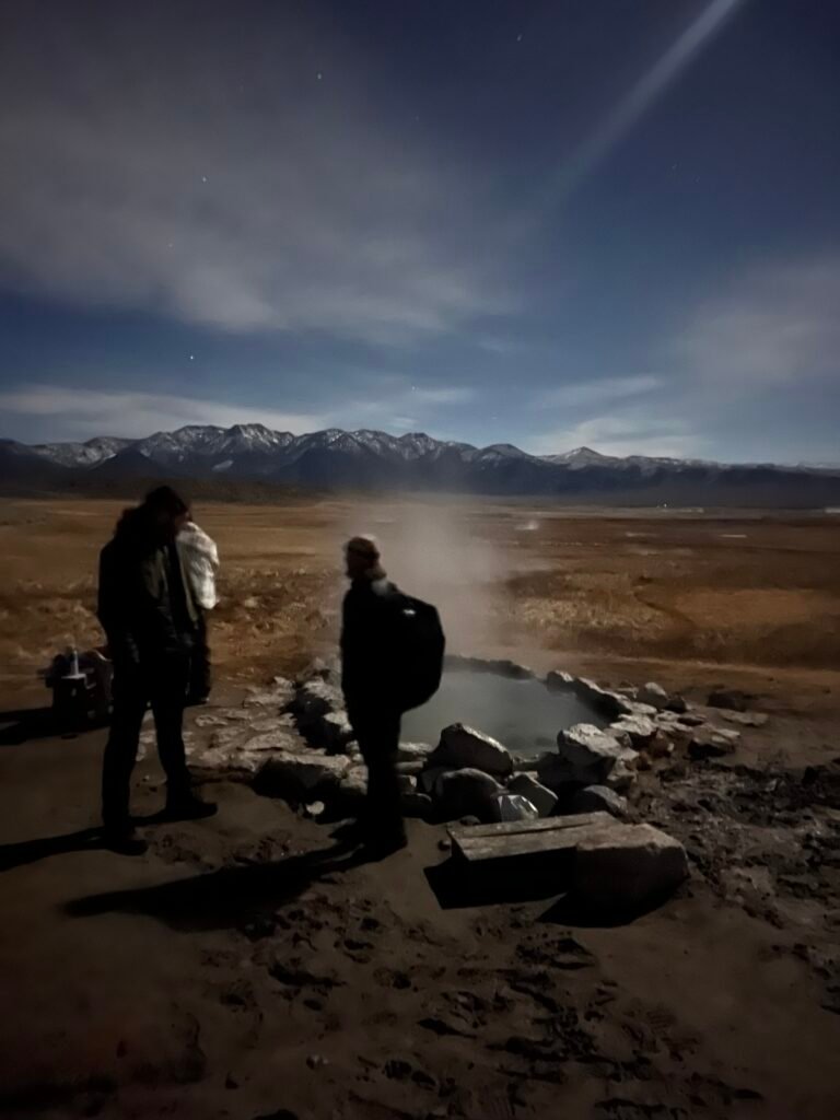 Steam rising off a hot spring at dusk in the Eastern Sierra