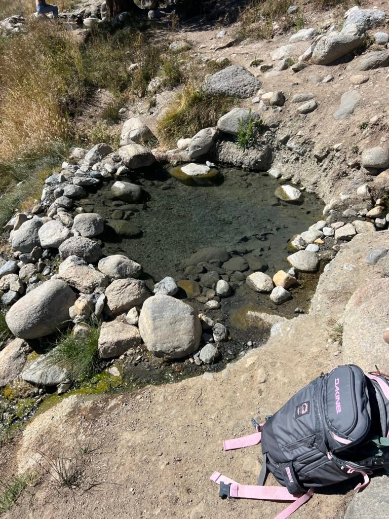 Small rock-lined soaking pool at Buckeye Hot Springs near Bridgeport