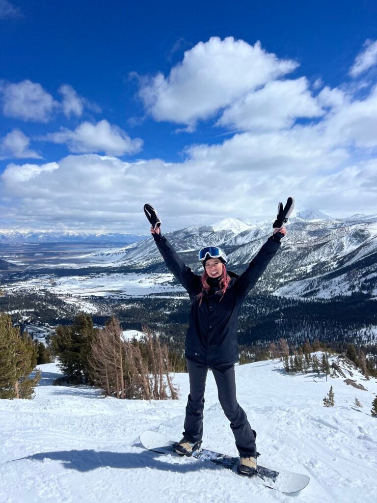 Arms up at the top of Mammoth Mountain on a bluebird day