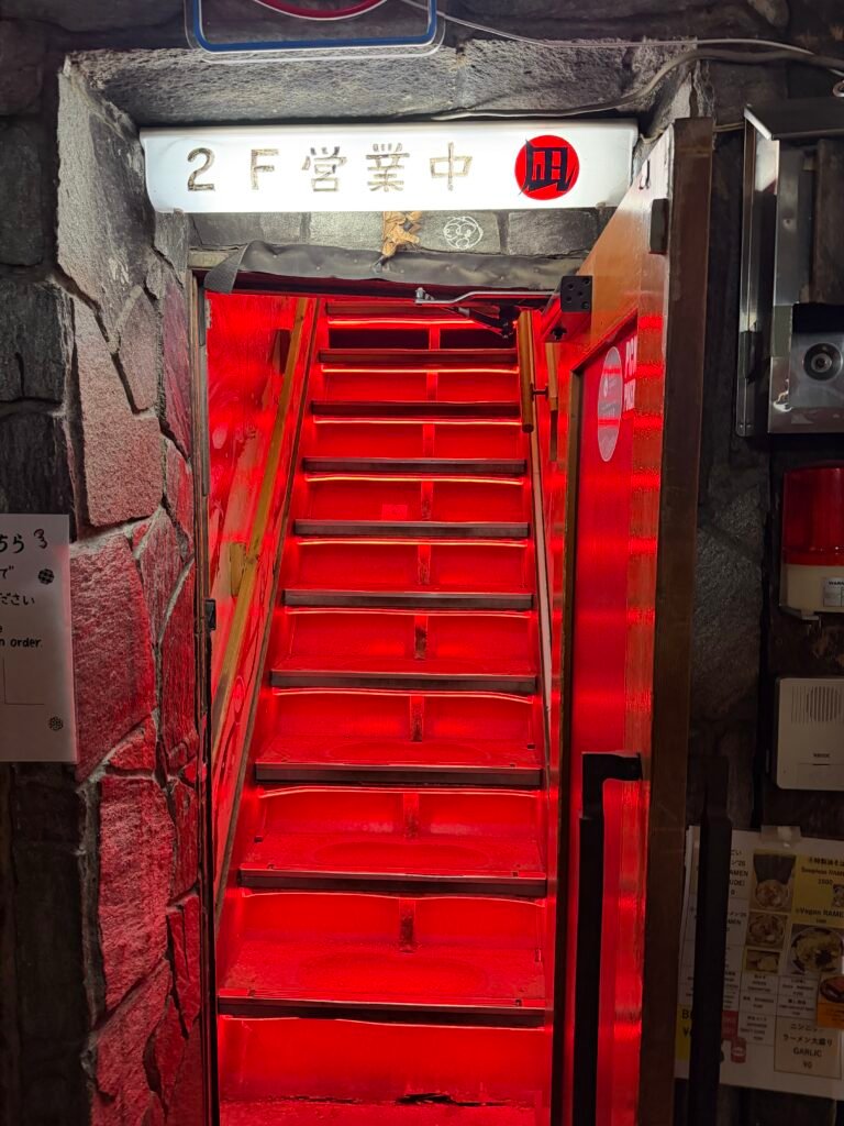 Red staircase up to Sugoi Niboshi Ramen Nagi in Shinjuku Golden Gai