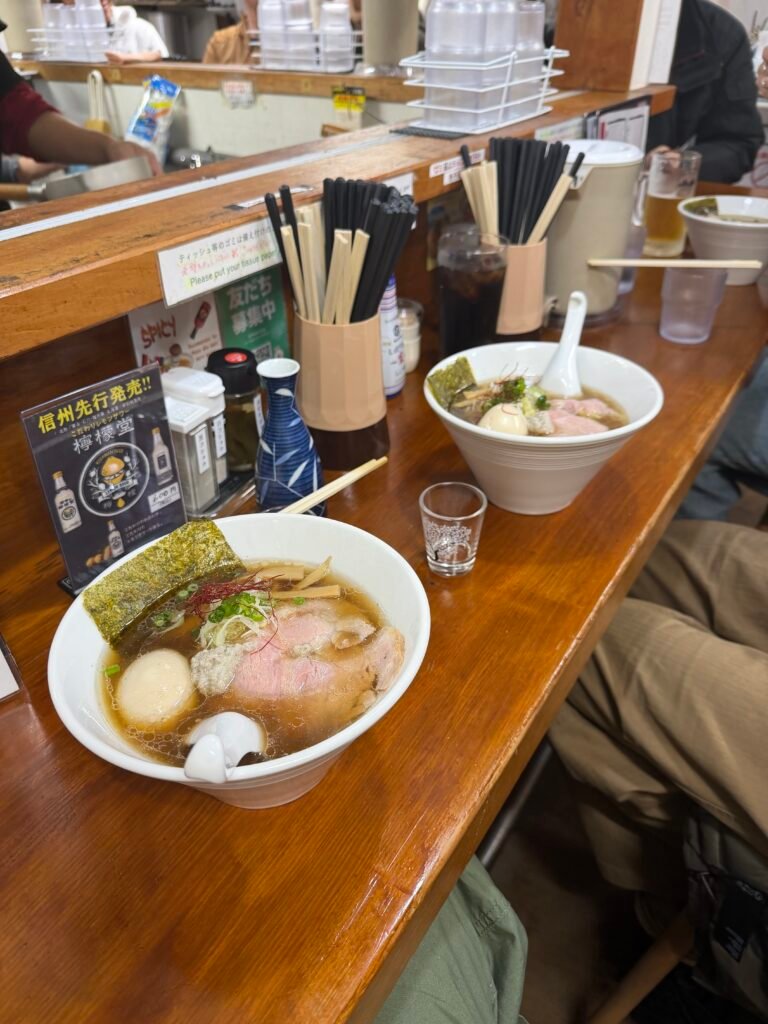 Two bowls of ramen at a counter