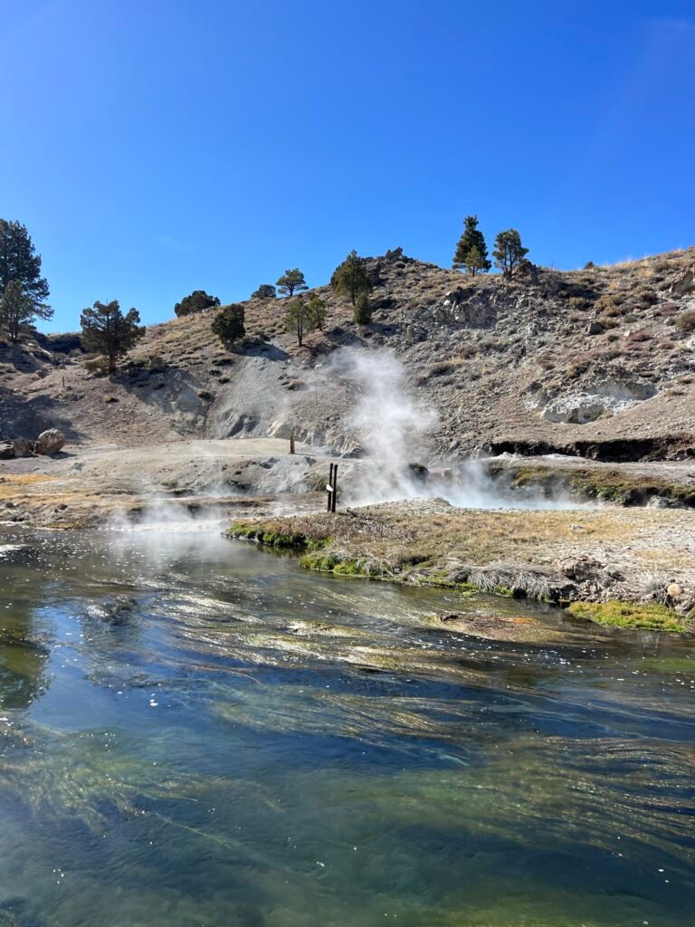 Steaming hot water flowing over rocks on a sunny day near Mammoth