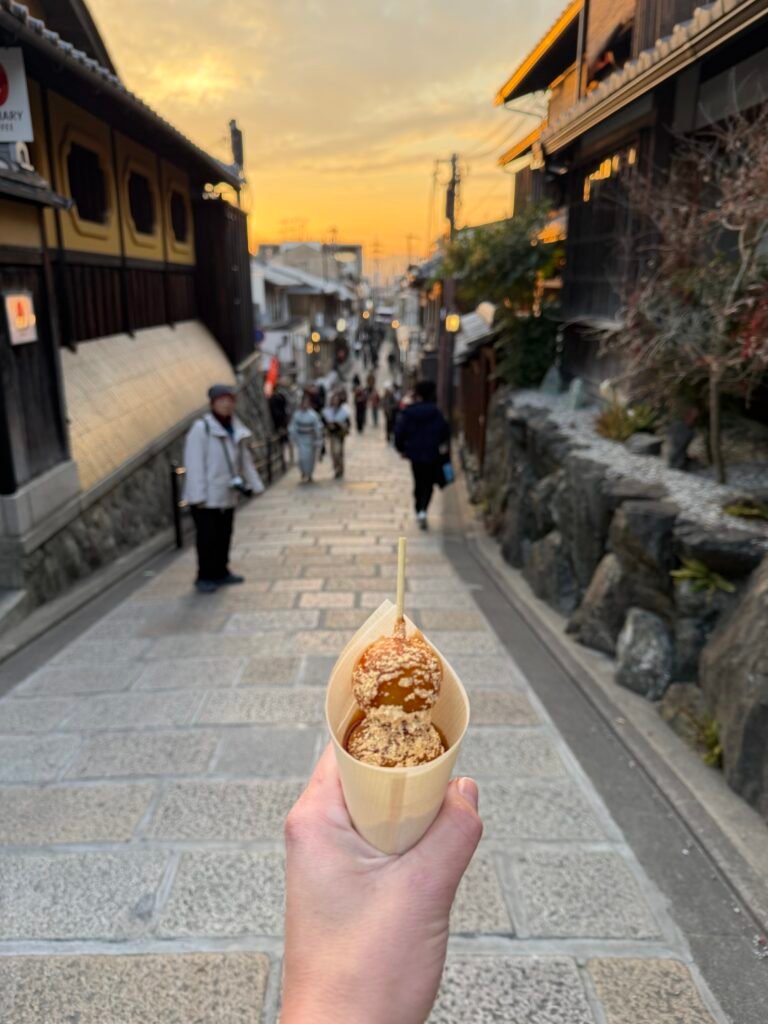 Holding a snack on a Kyoto street