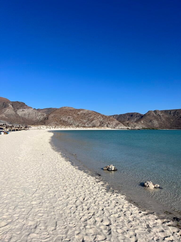 The curve of white sand and calm water at Balandra Beach