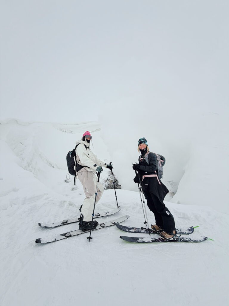Two skiers on a snowy ridge on a backcountry tour in Hokkaido