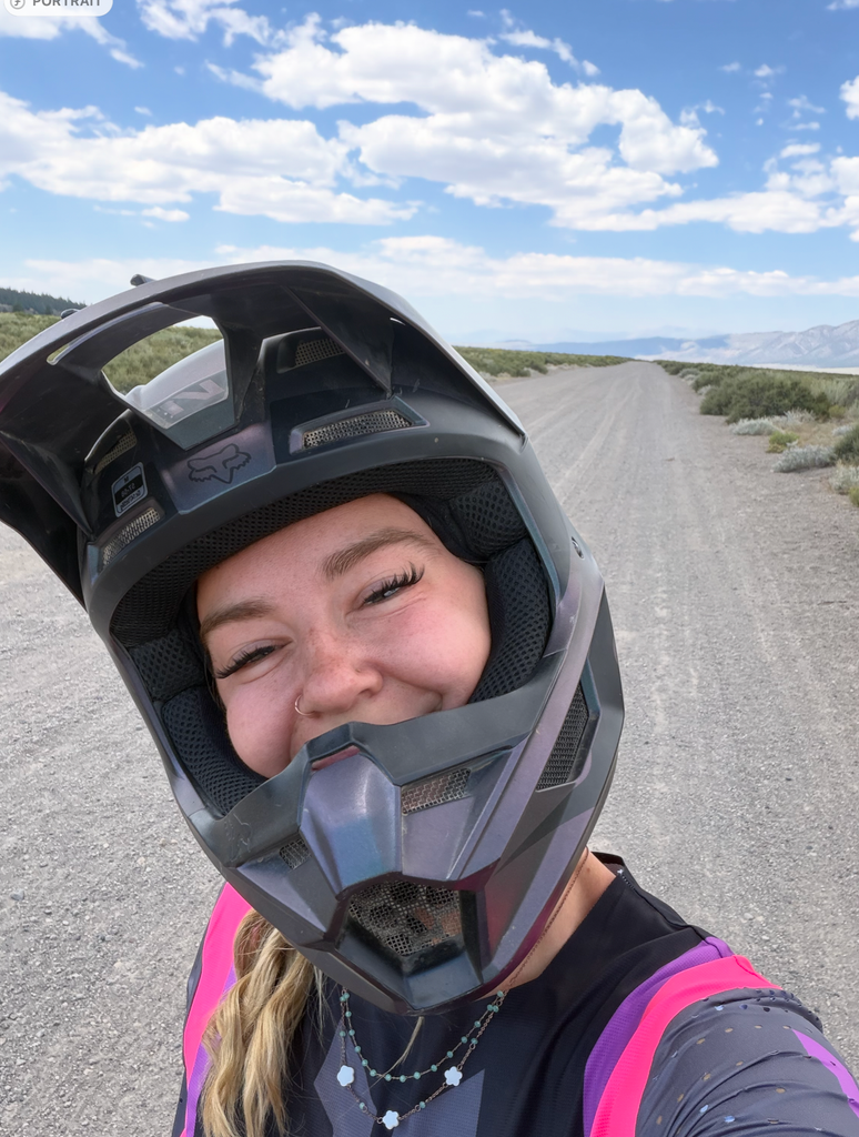 Helmet selfie, smiling on a dirt road near Mammoth