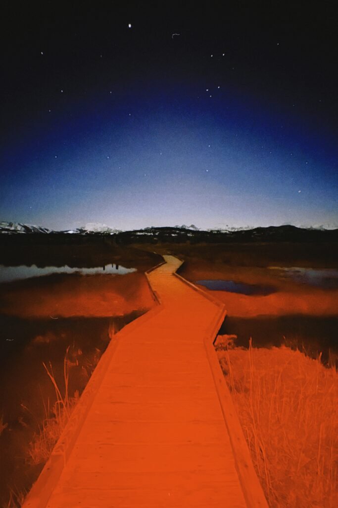 Boardwalk out to the hot springs at night under the stars